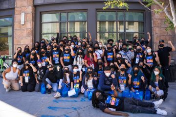 large group of students gathered together in front of a building