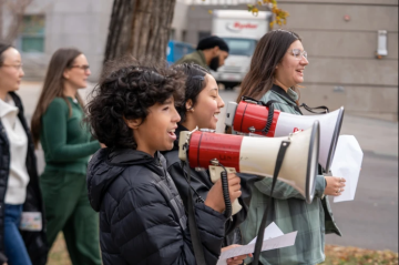 2 young leaders speaking into bullhorns